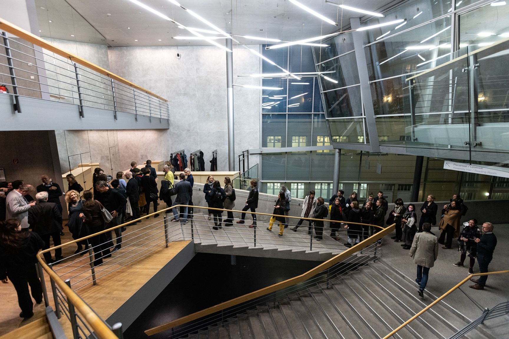 People walk up a wide staircase to the lecture hall.